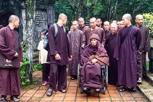 Thiền sư Thích Nhất Hạnh (ngồi xe lăn) cùng các tăng ni, Phật tử trong một buổi thiền hành tại chùa Từ Hiếu. Ảnh: Phúc Đạt.